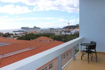 a balcony with a chair and a view of the ocean at D Apartment - your home with breathtaking Views in Funchal