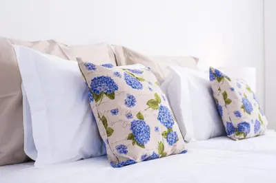 four blue and white pillows on a bed at Casa da Praça Double room - by Casas na Ilha in Funchal