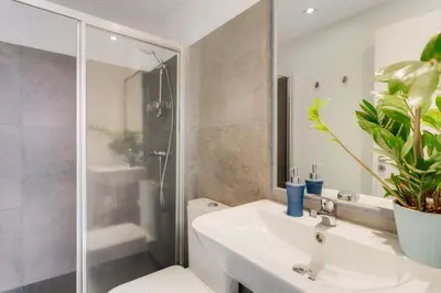 a bathroom with a sink and a shower and a toilet at Casa da Praça Double room - by Casas na Ilha in Funchal
