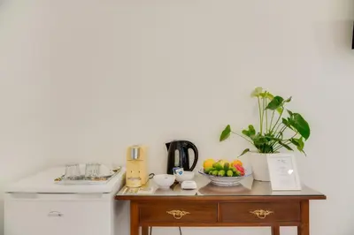 a kitchen with a table with a bowl of fruit on it at Casa da Praça Double room - by Casas na Ilha in Funchal