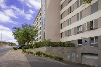 an empty street in front of a building at Margarida's Apartment com piscina e vista mar in Funchal
