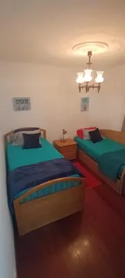 a bedroom with two beds and a chandelier at Casa Alencastre in Funchal