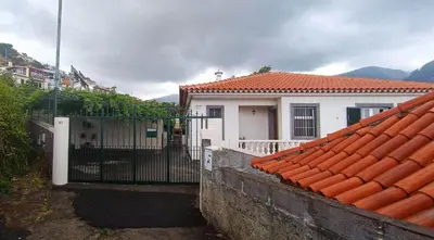 a white house with a gate in front of it at Casa Alencastre in Funchal