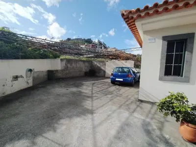 a car parked in a parking lot next to a house at Casa Alencastre in Funchal
