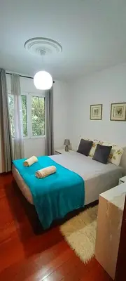 a bedroom with a large bed with a blue blanket at Casa Alencastre in Funchal