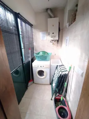 a small laundry room with a washing machine and a washer at Casa Alencastre in Funchal
