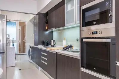 a kitchen with a microwave and a stove top oven at Blue Paradise Apartment in Caniço