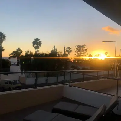 a sunset from the balcony of a building at Blue Paradise Apartment in Caniço