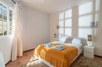 a bedroom with a bed with two towels on it at OurMadeira - Villa Vista Sol in Funchal