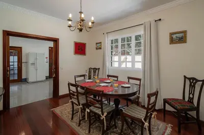 a dining room with a table and chairs at OurMadeira - Villa Vista Sol in Funchal