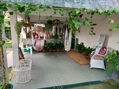 a patio with a bunch of plants and chairs at Tabua Village Madeira Suite VIP in Ribeira Brava