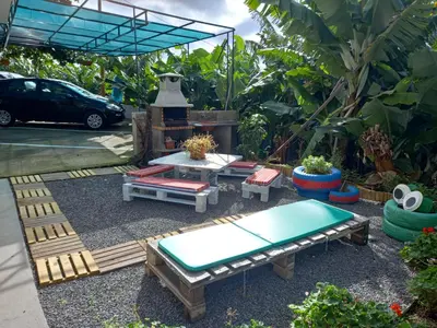 a backyard with a picnic table and a pool at Tabua Village Madeira Suite VIP in Ribeira Brava