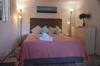 a bedroom with a bed with towels on it at Tabua Village Madeira Suite VIP in Ribeira Brava