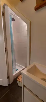 a bathroom with a shower and a sink at Madalena Beach Tiny House in Ponta do Sol