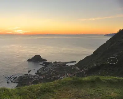 a small island in the ocean at sunset at Casa Azul - Ocean View in Porto Moniz