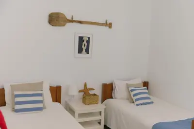 two beds sitting next to each other in a room at Casa Azul - Ocean View in Porto Moniz