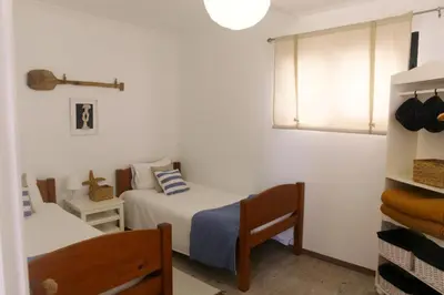a bedroom with two beds and a window at Casa Azul - Ocean View in Porto Moniz