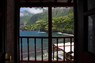 a view of the ocean from a room with a window at Madeira Black Sand House by Stay Madeira Island in Seixal