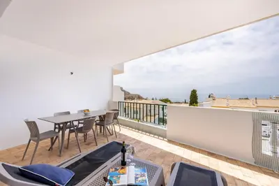 a room with a balcony with a table and chairs at CoolHouses Algarve Luz , 2 Bed apartment w/ sea view, Blue Ocean View (4972/AL) in Luz