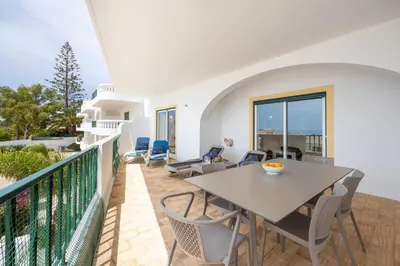 a balcony with a table and chairs and the ocean at CoolHouses Algarve Luz , 2 Bed apartment w/ sea view, Blue Ocean View (4972/AL) in Luz