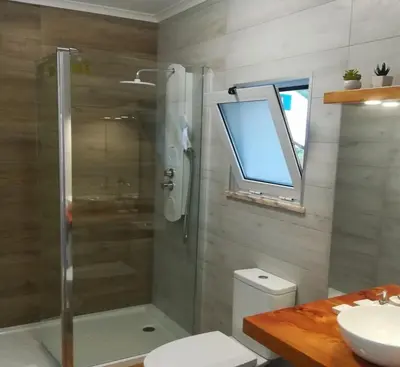 a bathroom with a shower and a toilet and a sink at Alo Baía São Lourenço in Santa Bárbara