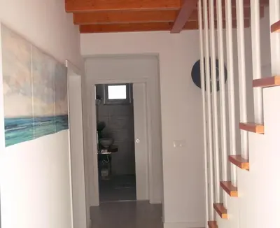 a hallway with white walls and wood ceilings at Alo Baía São Lourenço in Santa Bárbara