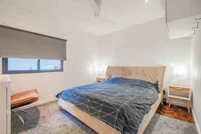 a bedroom with a bed with a blue comforter at Casa Familiar 3 Quartos in Funchal