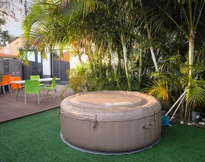 a large barrel sitting on the grass in a yard at Casa Familiar 3 Quartos in Funchal