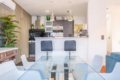 a dining room with a glass table and chairs at Casa Familiar 3 Quartos in Funchal