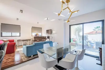 a dining room and living room with a glass table and chairs at Casa Familiar 3 Quartos in Funchal