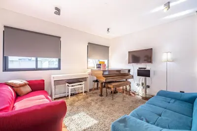 a living room with a couch and a piano at Casa Familiar 3 Quartos in Funchal