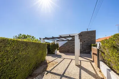 a gate to a house with a hedge at Villa Botelha in Sagres