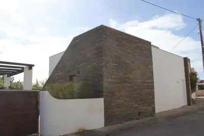 a brick building with a white wall at Villa Botelha in Sagres