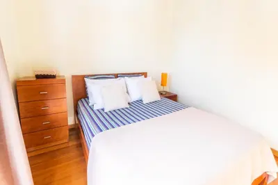 a bedroom with a bed with white sheets and white pillows at LULINA Two Bedroom by ALMA Holiday Rentals in Funchal