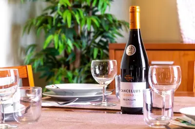 a bottle of wine sitting on a table with glasses at LULINA Two Bedroom by ALMA Holiday Rentals in Funchal