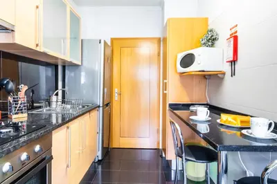 a small kitchen with a counter and a microwave at LULINA Two Bedroom by ALMA Holiday Rentals in Funchal