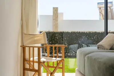 a room with a chair and a couch and a window at Villa Hobie Cat in Sagres