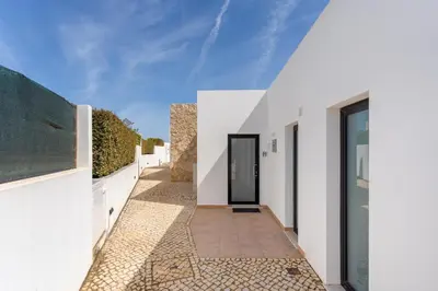 a hallway of a house with white walls and a doorway at Villa Hobie Cat in Sagres