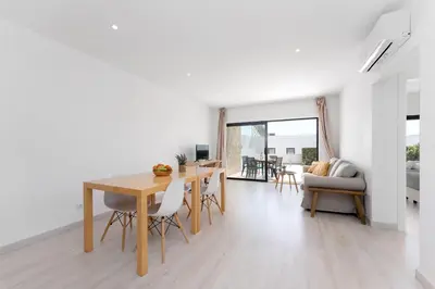 a dining room and living room with a table and chairs at Villa Hobie Cat in Sagres