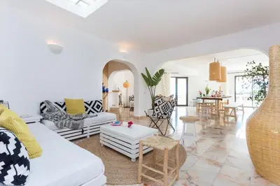 a living room with a white couch and a table at Ocean view beach villa in Budens