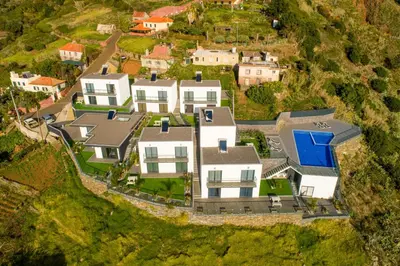 an aerial view of a house on a hill at OurMadeira - Sunset Cliff Villas in Fajã da Ovelha