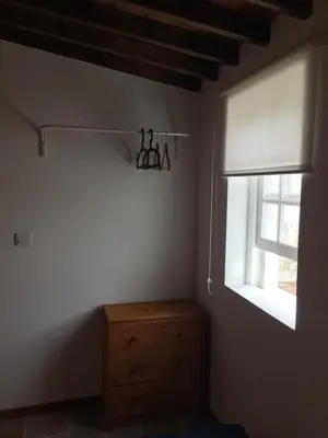 a bedroom with a window and a wooden dresser at Casa Malbusca in Almagrinha
