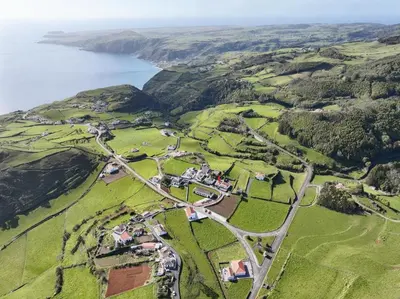 an aerial view of a village on a hill next to the water at Casa Malbusca in Almagrinha