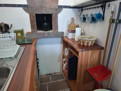 a small kitchen with a counter and a stove at Casa Malbusca in Almagrinha