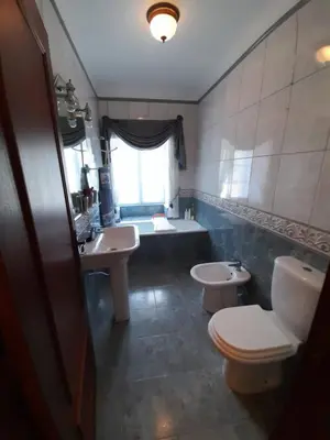 a bathroom with two sinks and a toilet and a tub at Quintinha da Romana in Câmara de Lobos