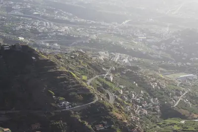 an aerial view of a mountain with a city at Quintinha da Romana in Câmara de Lobos