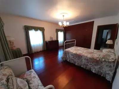 a living room with two beds and a couch at Quintinha da Romana in Câmara de Lobos