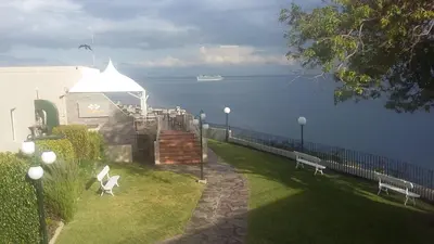 a park with two benches and a view of the water at Bright Studio in Funchal