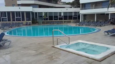 a large swimming pool with a hot tub in a building at Bright Studio in Funchal