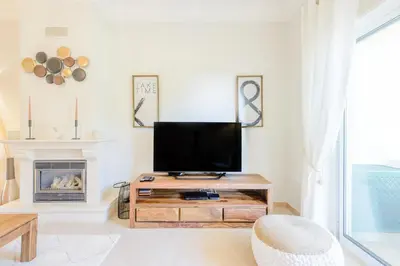 a living room with a tv and a fireplace at Casa Lomy - Boavista Resort and Spa in Quatro Estradas